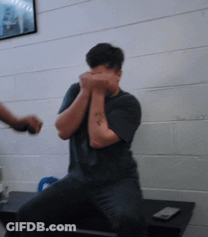 Man With Arm Tattoo Covering Face GIF