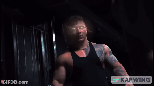Man With Arm Tattoo Looking At Camera GIF