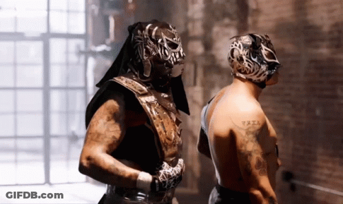 Man With Arm Tattoo Next To Masked Man GIF