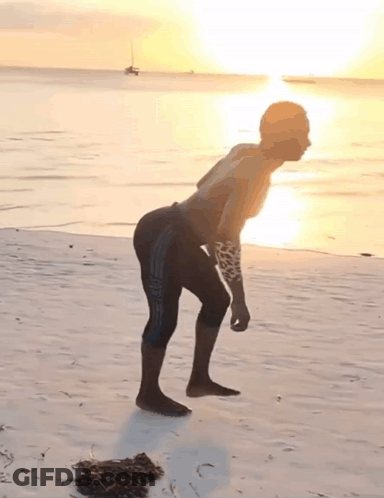 Man With Arm Tattoo On Beach GIF