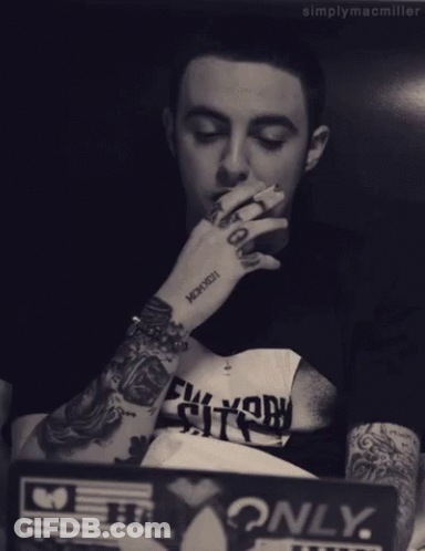 Man With Arm Tattoo Saying Mcmxcxii GIF