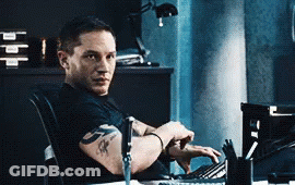 Man With Arm Tattoo Sitting At Computer GIF