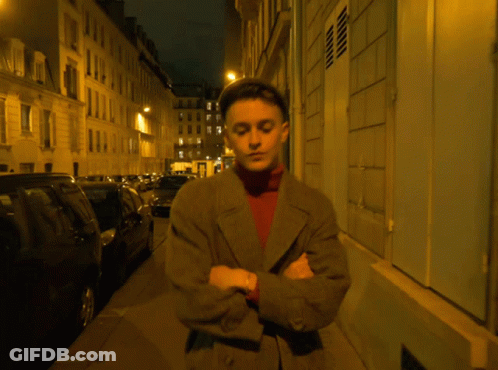 Man With Arms Crossed At Night Building GIF
