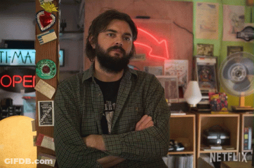 Man With Arms Crossed By Open Neon Sign GIF