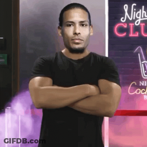 Man With Arms Crossed In Front Of Night Club Sign GIF