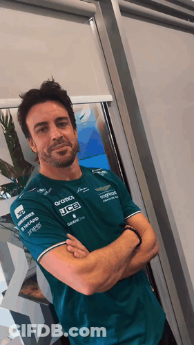 Man With Arms Crossed In Green JCB Shirt GIF