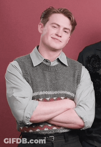 Man With Arms Crossed In Grey Vest GIF