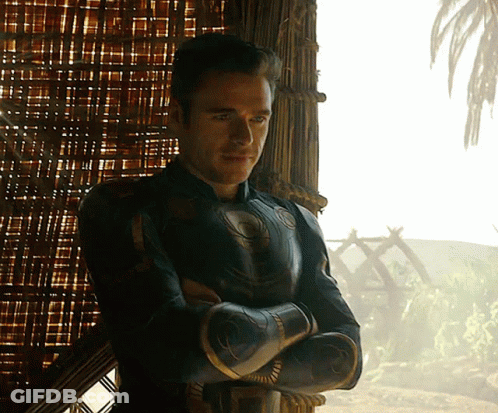 Man With Arms Crossed Standing In Front Of Window GIF