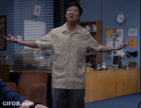 Man With Arms Outstretched In Front Of Clock GIF