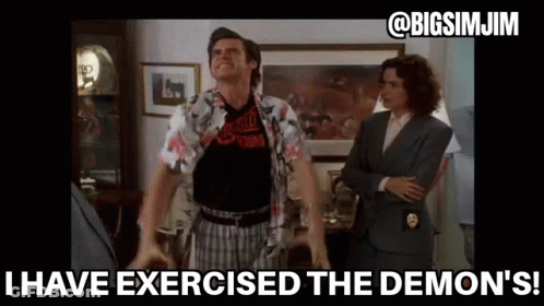 Man With Arms Outstretched In Living Room With Woman In Suit GIF