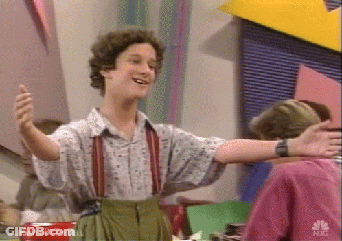 Man With Arms Outstretched Wearing Suspenders GIF