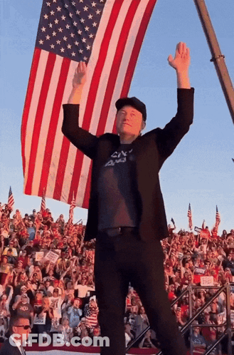Man With Arms Up In Front Of American Flag GIF