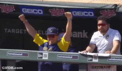 Man With Arms Up In Front Of Geico Sign GIF