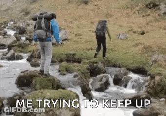 Man With Backpack Crossing River While Another Stands On Rock GIF