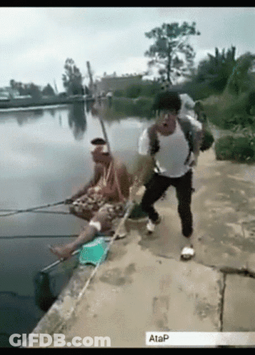 Man With Backpack Fishing In Lake, Another On Shore GIF