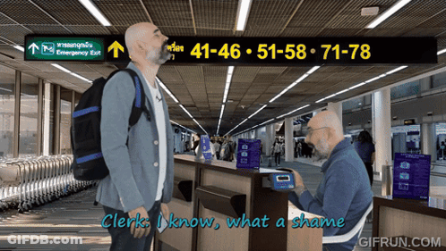 Man With Backpack In Front Of Emergency Exit GIF