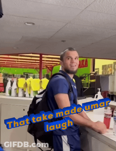 Man With Backpack In Front Of Green Sign Saying Aka GIF