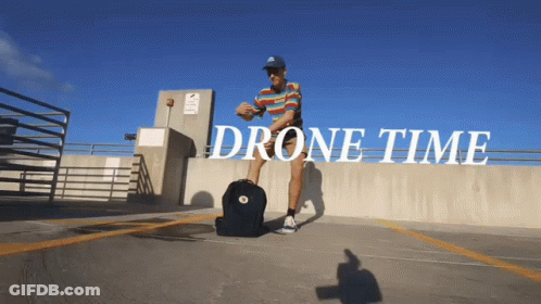 Man With Backpack In Parking Lot Saying Drone Time GIF
