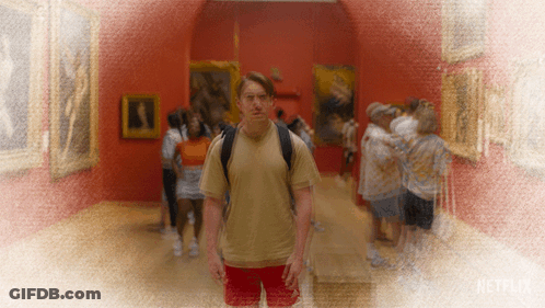 Man With Backpack Stands In Museum With Netflix Logo GIF
