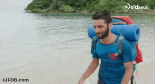 Man With Backpack Walking On Beach Eitb.eus GIF