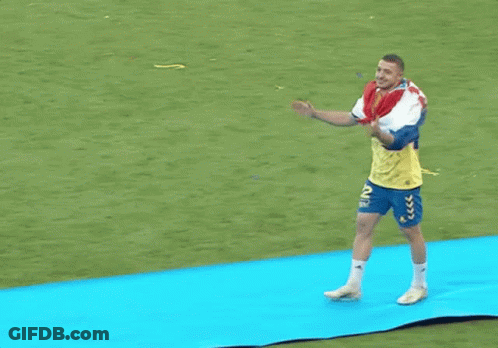 Man With Backpack Walking On Blue Mat GIF