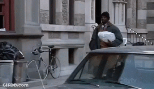 Man With Bag Standing Next To Car With CityTV On Windshield GIF