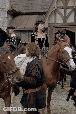 Man With Bag Standing Next To Woman Riding Horse GIF