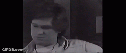 Man With Bandage On Eye Standing Next To Another Man GIF