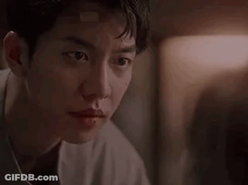 Man With Bandage On Forehead Looking At Camera GIF