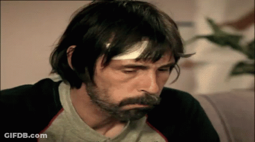 Man With Bandage On Head In Gray Shirt GIF