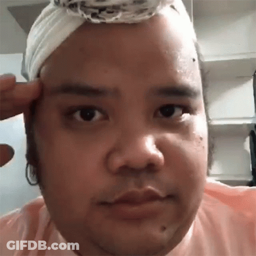 Man With Bandage On Head Looking At Camera GIF