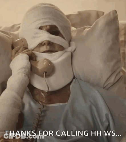 Man With Bandage On Head Talking On Phone GIF