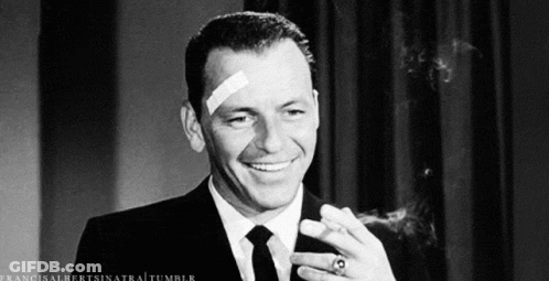 Man With Bandage Smiling And Smoking Cigar GIF