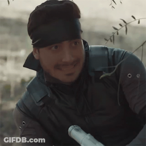 Man With Bandana Holding Rifle GIF