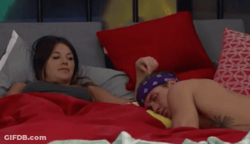 Man With Bandana Laying On Bed Next To Woman GIF
