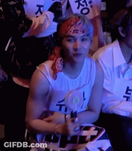 Man With Bandana Sitting In Crowd GIF