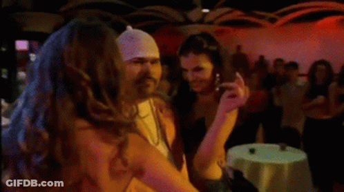 Man With Bandana Standing Next To Woman GIF