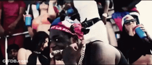 Man With Bandana Surrounded By Women GIF