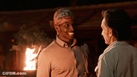 Man With Bandana Talking By Fireplace GIF