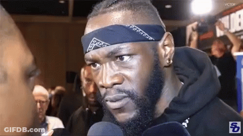 Man With Bandana Talking Into Microphone GIF