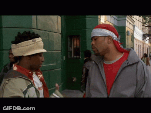Man With Bandana Talking To Another Man GIF