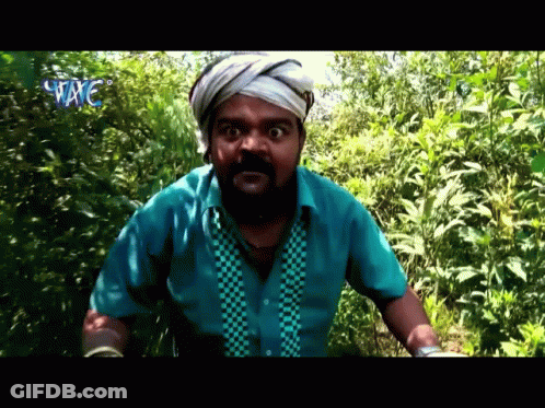 Man With Beard And Bandaged Headband Standing In Woods GIF