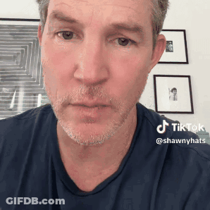 Man With Beard And Blue Shirt Has TikTok Sticker On Face GIF