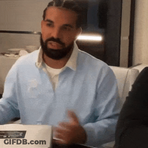 Man With Beard And Braids Sitting At Table GIF