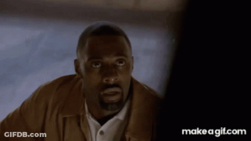 Man With Beard And Brown Jacket Looking At Camera GIF