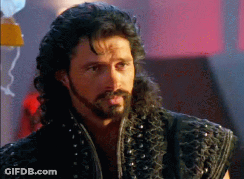 Man With Beard And Curly Hair In Black Vest GIF