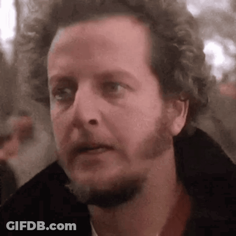 Man With Beard And Curly Hair Looking At Camera GIF