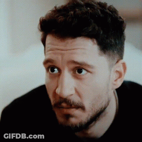 Man With Beard And Curly Hair Looking Serious GIF