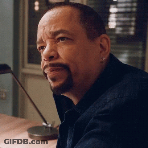 Man With Beard And Earrings Sitting At Table GIF