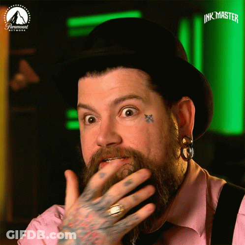 Man With Beard And Face Tattoos Wearing Paramount Hat GIF
